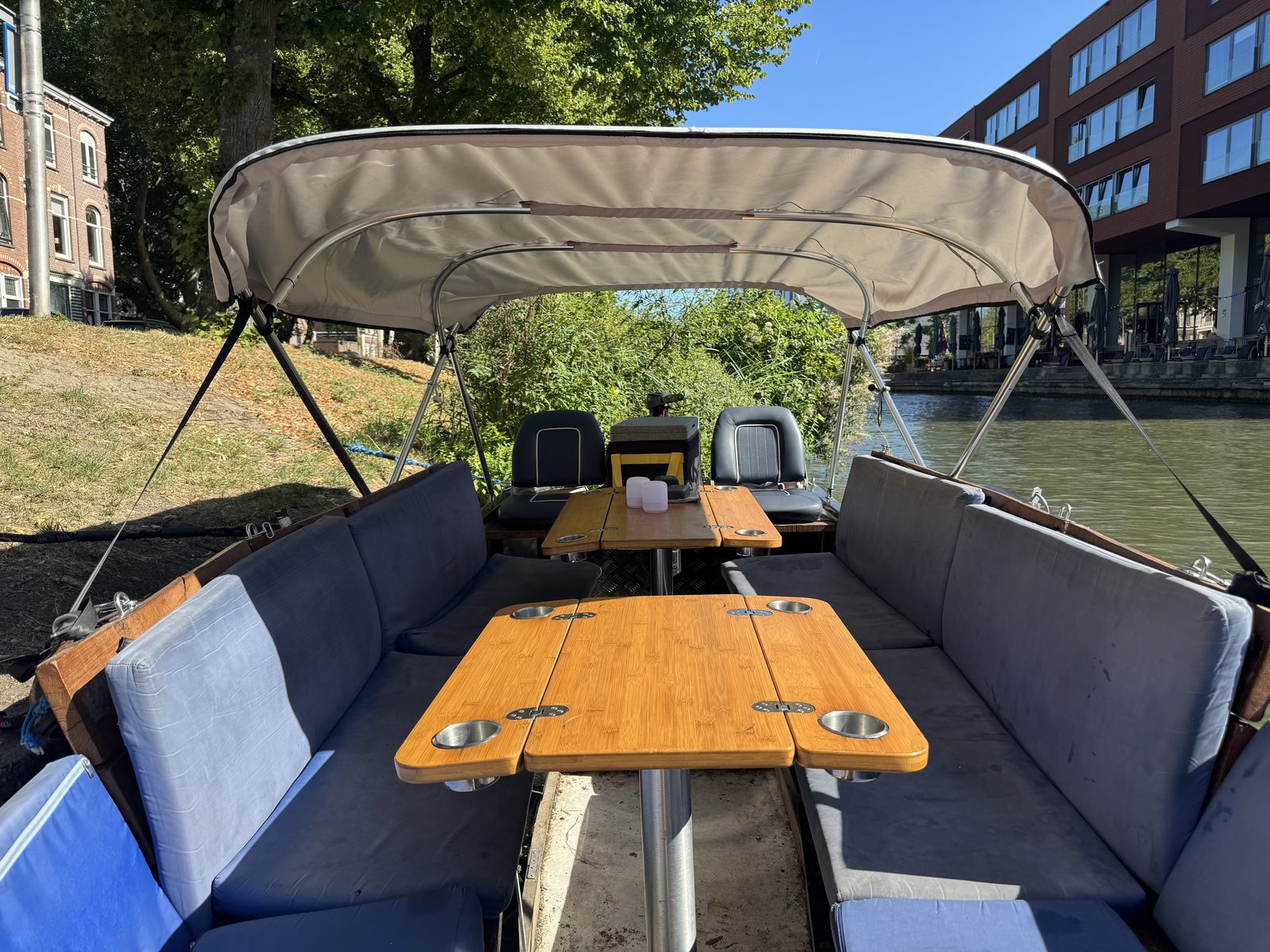 View from inside the boat showing the bimini top above the seating